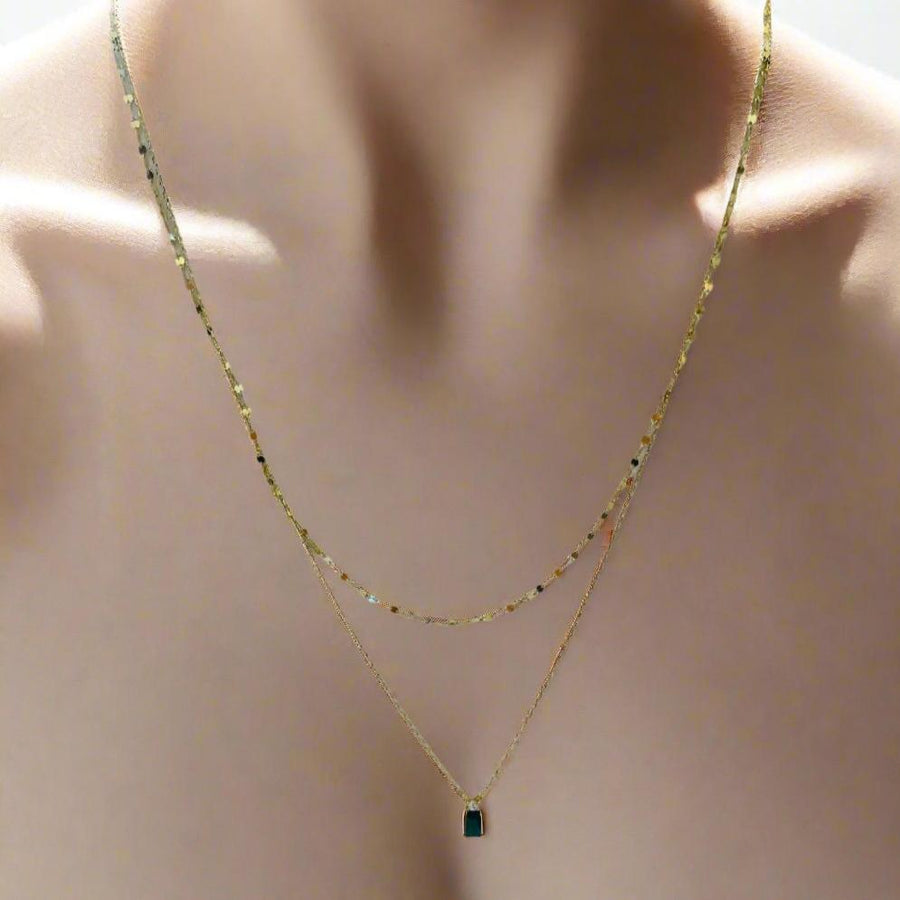 Dainty layer with green stone.